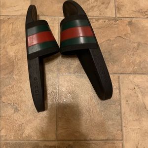 Black Gucci slides.
